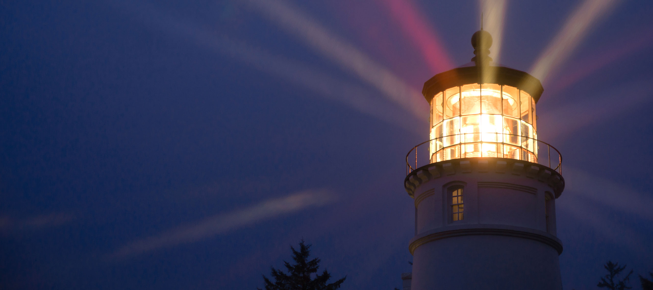 Lighthouse shining in the night symbolizes leadership guiding the way.