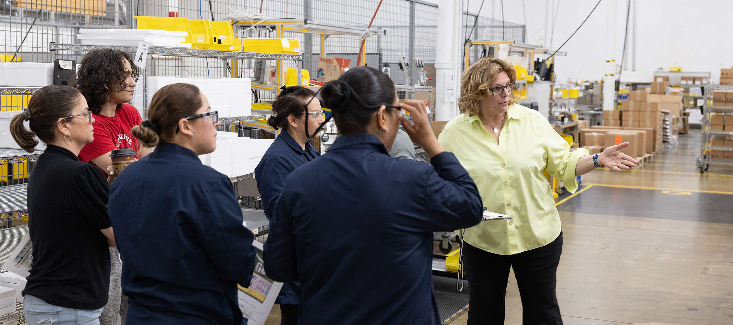 Associates participate in a gemba walk on the factory floor